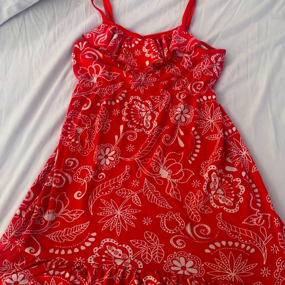 It’s a red dress with different designs on it like flowers, leafs. - Picture 1 of 1
